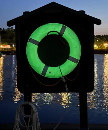 Photoluminescent GLOrope Kisby ring approved for Royal Canadian Navy use, shown glowing at dusk in lifering housing